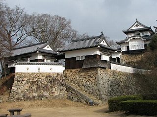備中松山城天守閣と復元された建物群の写真